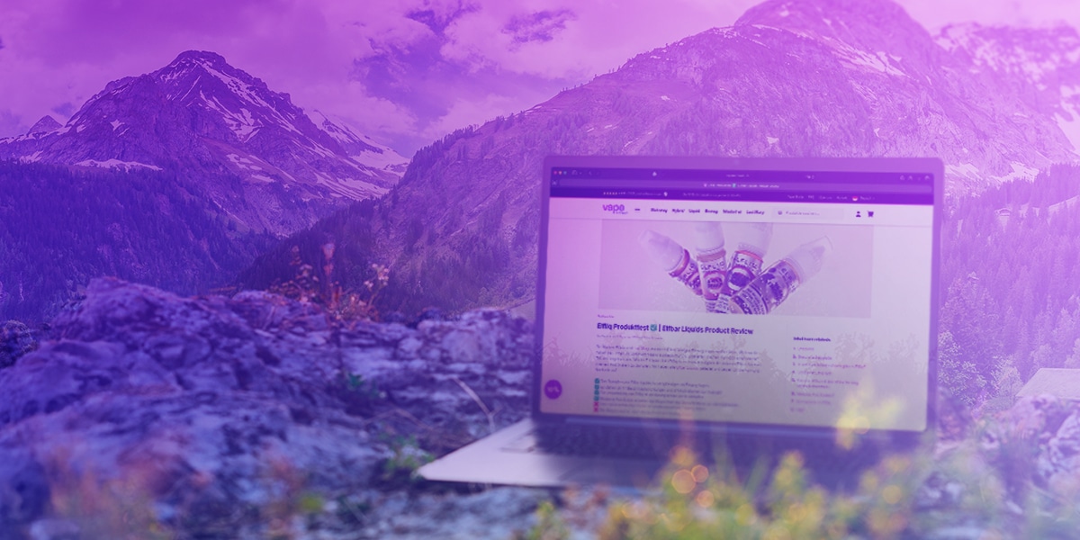 Laptop with vape shop website open in front of a mountain landscape, purple color scheme, nicotine content 20 mg